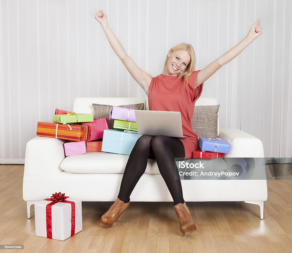 Beautiful young woman buying presents Beautiful young woman buying presents in Internet Adult Stock Photo