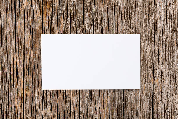 istock Empty white card over old textured wooden background 154403702