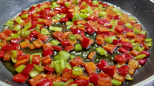 chopped green and red peppers fried in oil