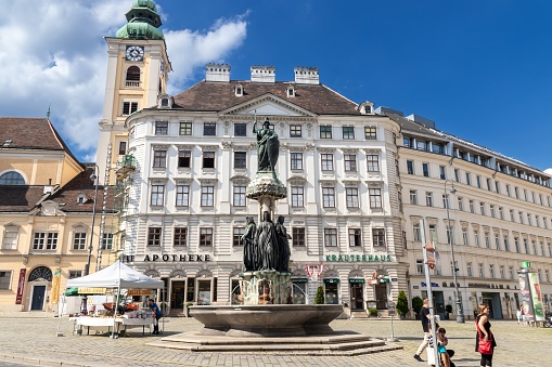Vienna, Austria - July 7, 2016: Mid-19th century bronze, granite and limestone fountain.