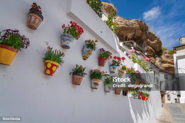Colorful Flower Pots And Rock Overhangs Setenil De Las Bodegas Andalusia Spain Stock Photo - Download Image Now