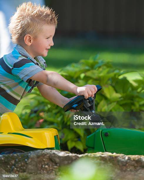 Boy With Tractor Stock Photo - Download Image Now - Child, Driving, Toy Car