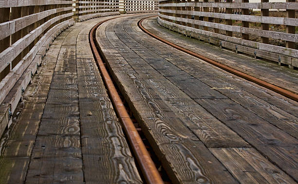 Curving railroad tracks on bridge stock photo