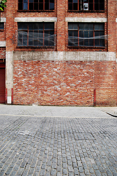 istock Urban background UK - Red brick wall with sidewalk 154416064