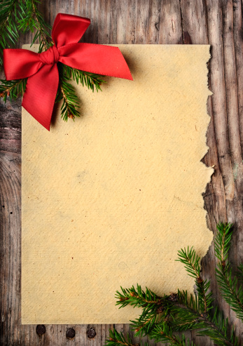 Christmas decoration and vintage paper on wooden background