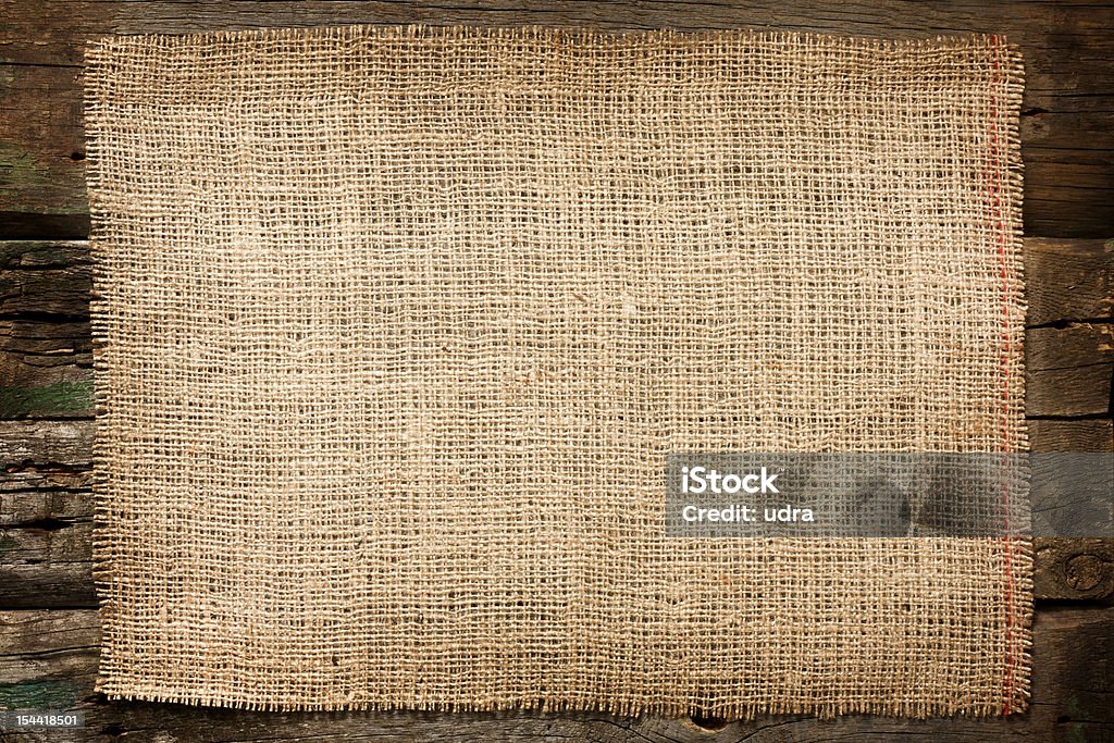 Jute canvas vintage background on boards Burlap jute canvas vintage background on wooden boards Backgrounds Stock Photo