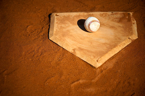 istock Youth League Baseball on Home Base Close Up 154420468