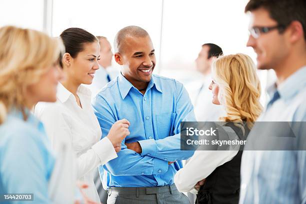 Laughing Businesspeople Talking In The Office Stock Photo - Download Image Now - Networking, Business, Convention Center