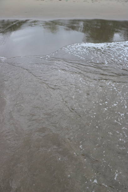 istock Trail of waves that wash on the beach 1544213795