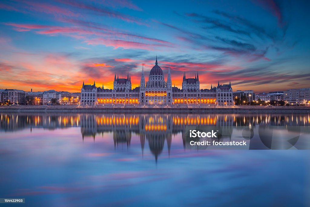 Looking at Hungarian parliament from across water at night The Hungarian parliament in morning light. Budapest Stock Photo