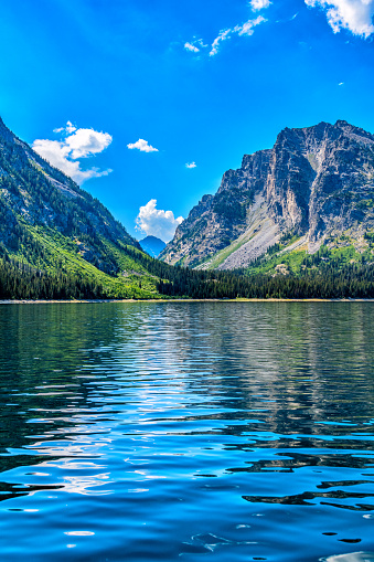 The mountains reflecting in Jackson Lake at Grand Teton National Park, Wyoming, on a summer afternoon.