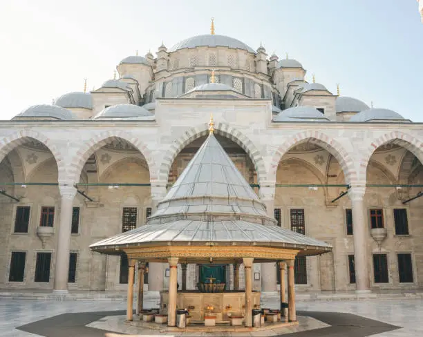 Photo of Fatih Mosque or Conqueror's Mosque in Istanbul, Turkey. Beautiful Fatih camii is landmark of Istanbul. Panorama of mosque courtyard, old muslim Turkish architecture. Travel, culture and tourism theme
