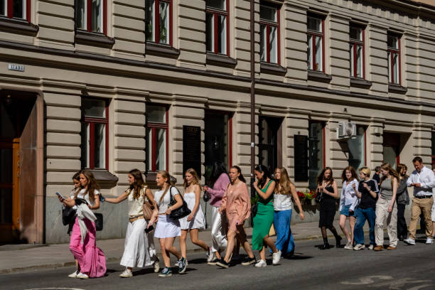 Stockholm, Sweden Stockholm, Sweden June 13, 2023 Swedish high school graduates marching on the street at Odenplan to their high school graduation ceremony. studenten stock pictures, royalty-free photos & images