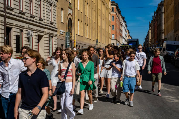 Stockholm, Sweden Stockholm, Sweden June 13, 2023 Swedish high school graduates marching on the street at Odenplan to their high school graduation ceremony. studenten stock pictures, royalty-free photos & images