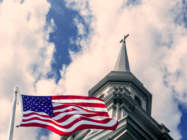 istock American flag and church rooftop with cross over dramatic sky 1544255828