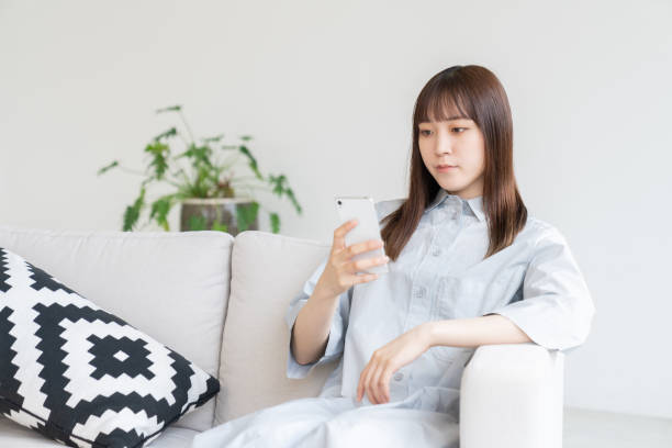istock attractive Asian woman using a smart phone 1544273364
