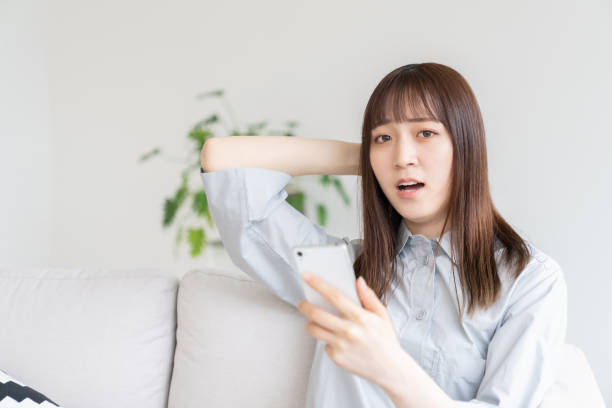 istock attractive Asian woman using a smartphone,think, 1544273393