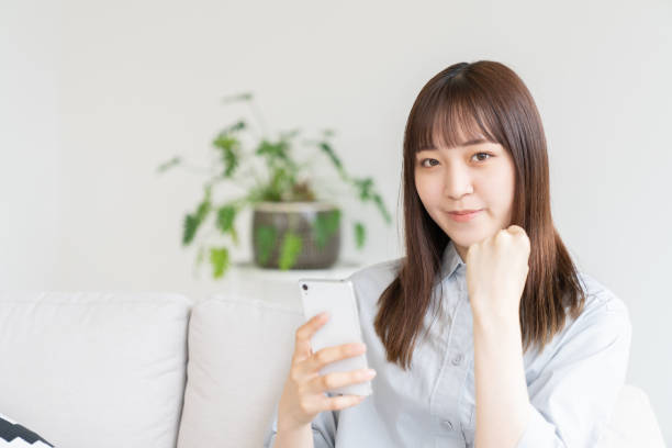 istock attractive Asian woman using a smart phone 1544277141