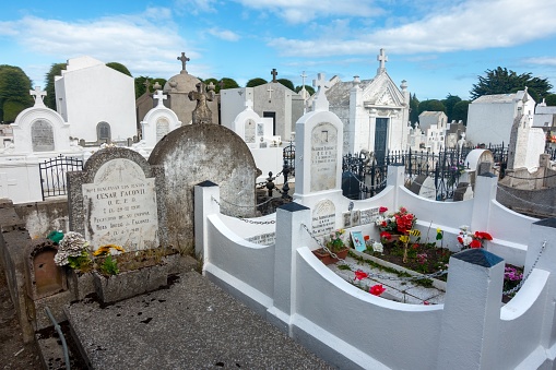 Punta Arenas, Chile - March 02, 2023:  Famous Sara Braun Public Cemetery of Punta Arenas or Cementerio Municipal with White Walls and Tombstone Graveyards Detail
