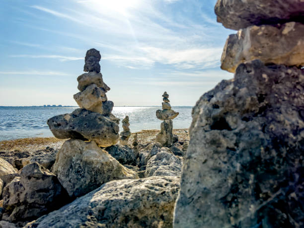 istock Balanced rock piles on rocky beach in sunny day 1544295646