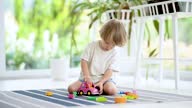 istock Cute toddler boy playing with plastic building block blocks construction set on the floor at home 1544355667