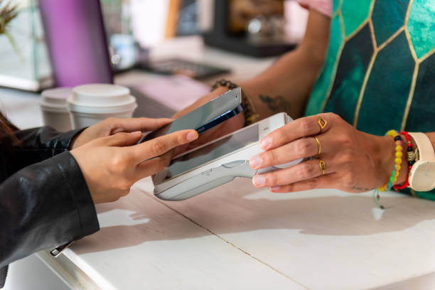 istock Woman when paying with cellphone 1544398802