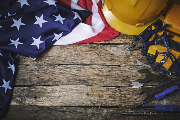istock US flag, set construction tools and protective helmet wooden background.Concept for Labor Day first May. 1544422236