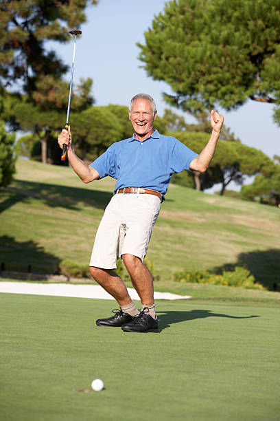 istock Senior Male Golfer On Golf Course Putting A Shot 154448408