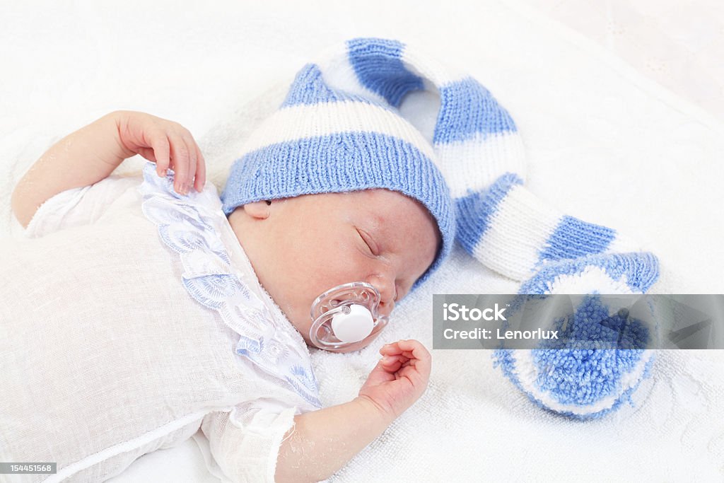 newborn baby (at the age of 7 days) sleeps newborn baby (at the age of 7 days) sleeps in a knitted striped hat Baby - Human Age Stock Photo