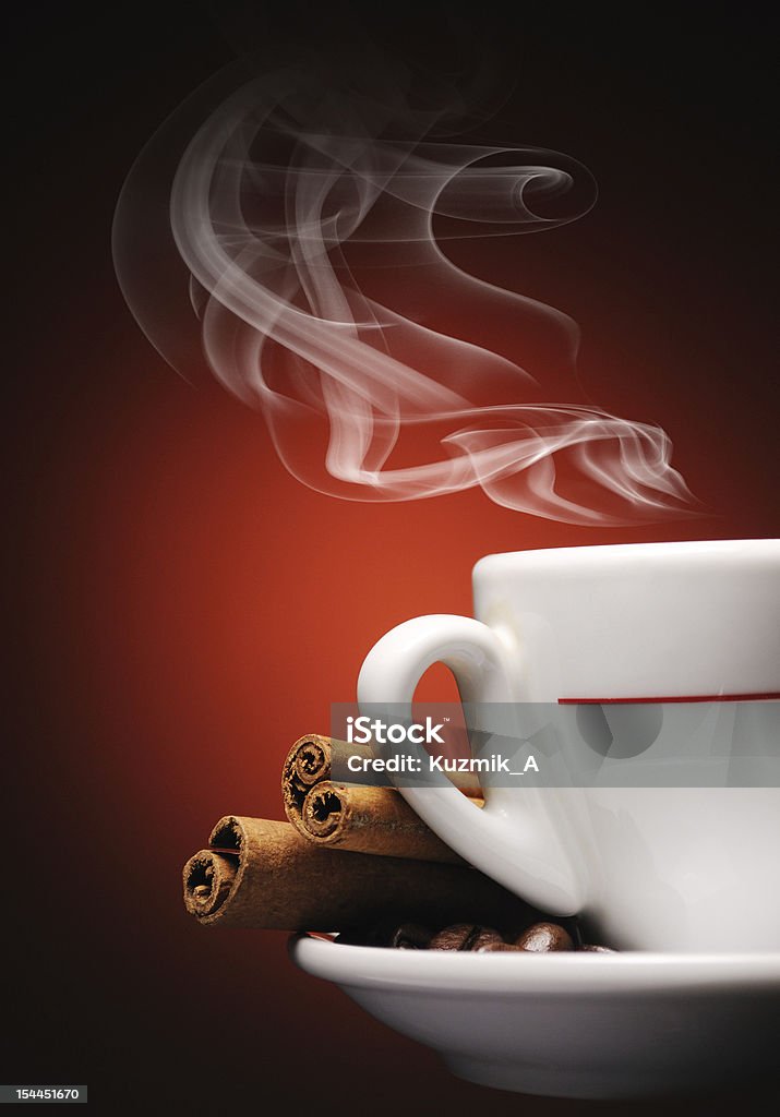 Steaming cup of coffee Steaming cup of coffee, cinnamon sticks and coffee beans. Breakfast Stock Photo