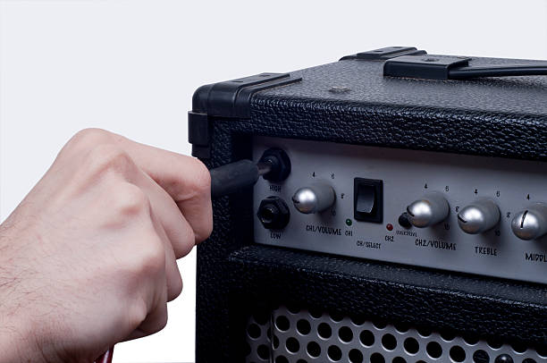 istock Humand Hand Plug the jack in Guitar Amplifier 154451773