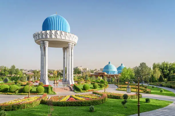 Awesome view of scenic rotunda at the Memorial Shakhidlar Hotirasi complex in Tashkent, Uzbekistan. Blue domes of Museum of Victims of Political Repression are visible at right side.