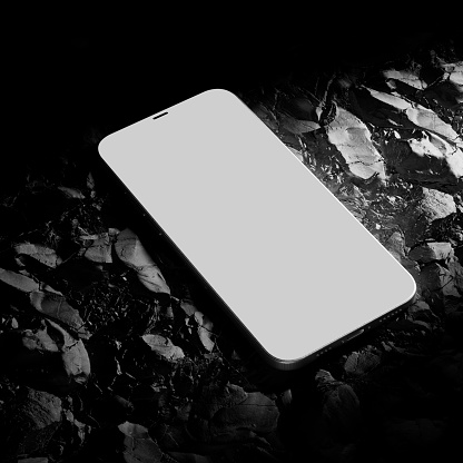 Mobile phone on natural rocks black white product podium mockup