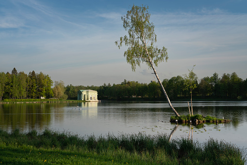 View of the small island and the Venus Pavilion on a White Lake on the territory of the Gatchina Palace and Park Complex on a sunny summer day, Gatchina, St. Petersburg, Russia