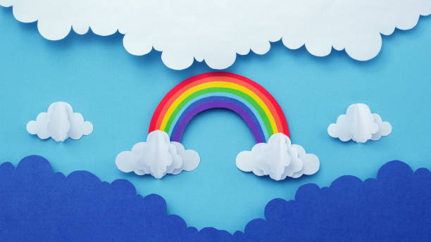 istock Rainbow on blue sky with clouds  made of paper cutout. paper art creative background. 1544703236