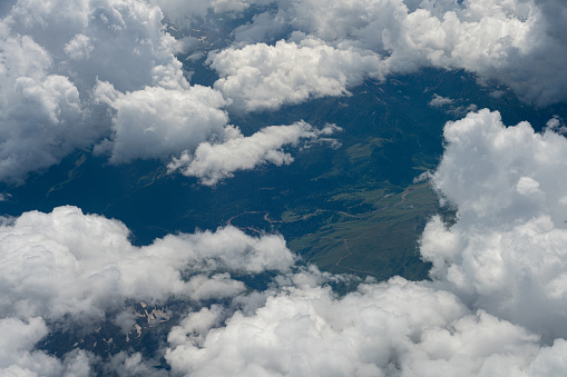 Caucasus mountains under the white clouds, airplane point of view