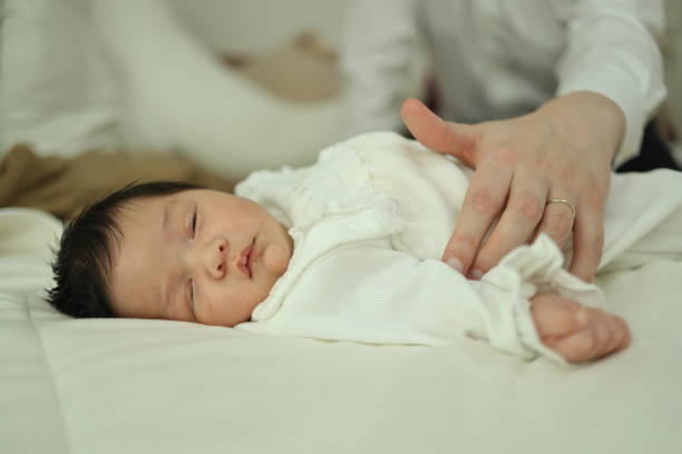 istock Father ouching newborn baby at home 1544711094