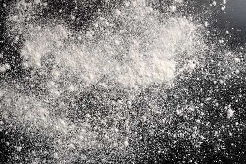 Wheat flour on black background