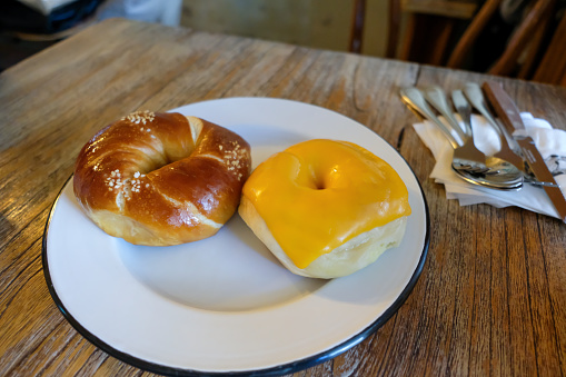 Salt and cheese bagel served on the plate
