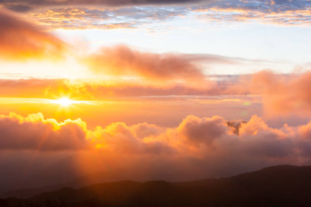the sun rising over the mountain range. - dawn sunrise cloud cloudscape imagens e fotografias de stock