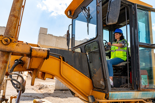 female construction worker Operating With Excavator