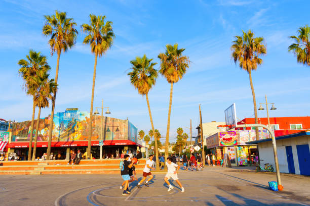 Los Angeles, California - December 29, 2022: Group of Teenagers Playing Basketball Game at Venice Beach