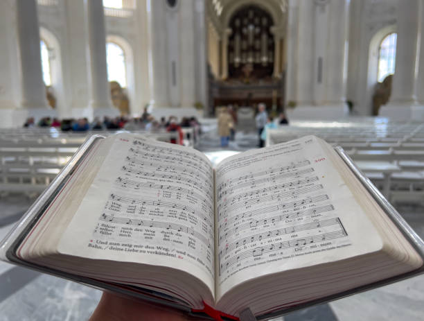 Person holding a sheet music book in cathedral of St. Blasius