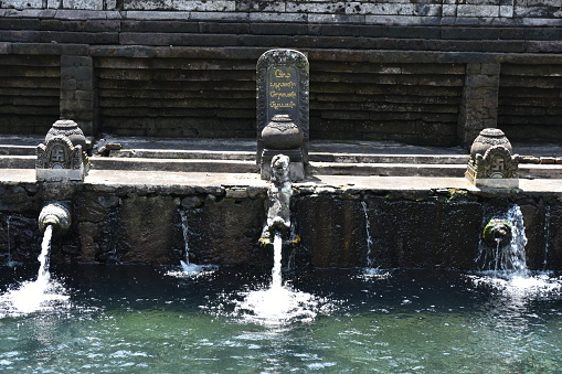 Karlsbad, Czech Republic, June 29, 2022: With granite and chromed iron set spring with medicinal water in Karlovy Vary, from which visitors and sick people can help themselves free of charge