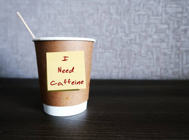 istock Coffee cup with handwritten sticky note I NEED CAFFEINE on copy space background, concept of caffeine addiction, daily coffee intake to boost energy and wake up in morning or afternoon 1544941861