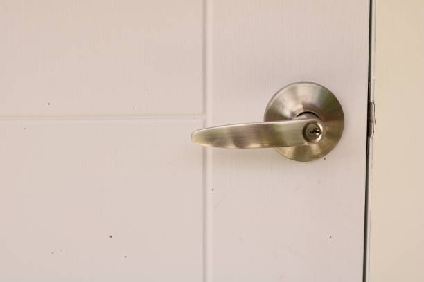 istock door handle with key on white door closeup 1544968089