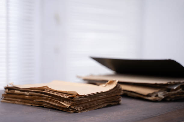 Old file folder with stacks of old and torn papers