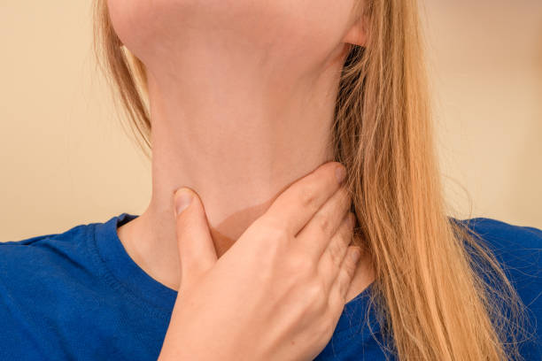 istock Sore throat, woman holding her neck 1544997516