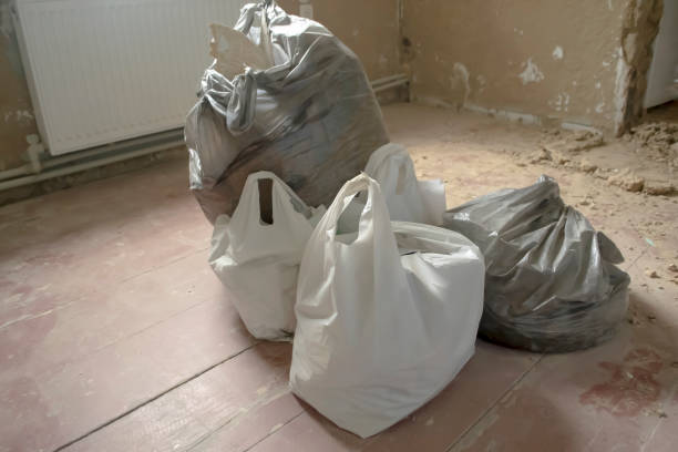 istock Packages with a construction garbage stand on a dirty floor. Dirt during repairs. Construction garbage in packages. 1545020496
