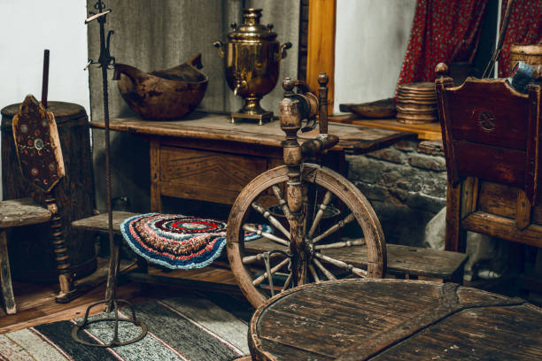 Living room with antique furniture and outdated utensils. Rural life of Russian peasants. Premises of old hut. Living room with antique furniture and outdated utensils. Rural life of Russian peasants. Spinning wheel and samovar. Premises of old hut. Inside view. rusty old wagon detail stock pictures, royalty-free photos & images